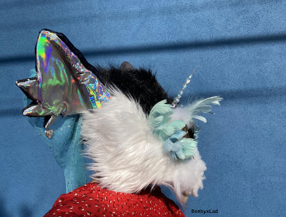 gryphon head side it has a unicorn horn made of iridescent plastic