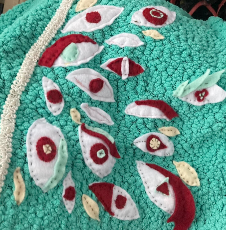 Felt eyes on a meshy shirt